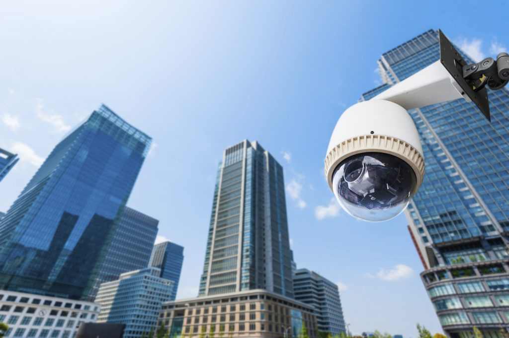 CCTV Camera or surveillance oeprating with building in backgroun