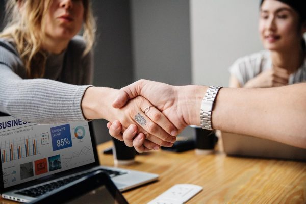 two people shaking hands in the office