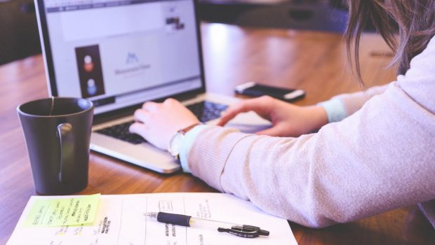 Person Using Laptop Computer on Table