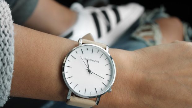 Beige Strap Silver Round Analog Watch Behind Adidas White and Black Superstar