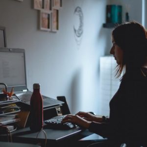 woman in black long sleeve shirt using computer